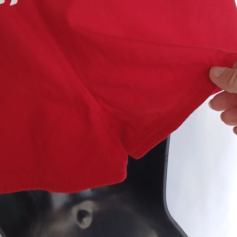 Red Nike swim shorts, Jr size medium